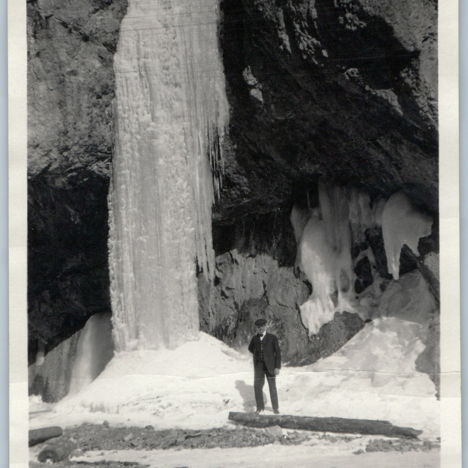c1920s Frozen Waterfall Snapshot Photo Man Suit Cap Winter Ice Cave Column Vtg
