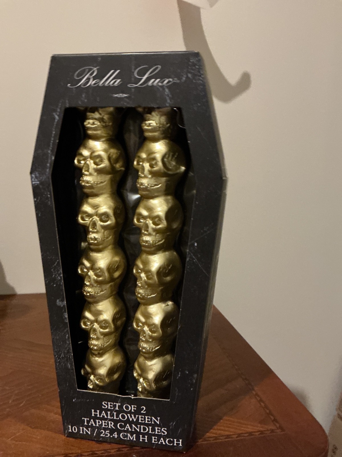 of two Bella Lux Gold Halloween Stacked Skulls Taper Candles, measuring 10 inche