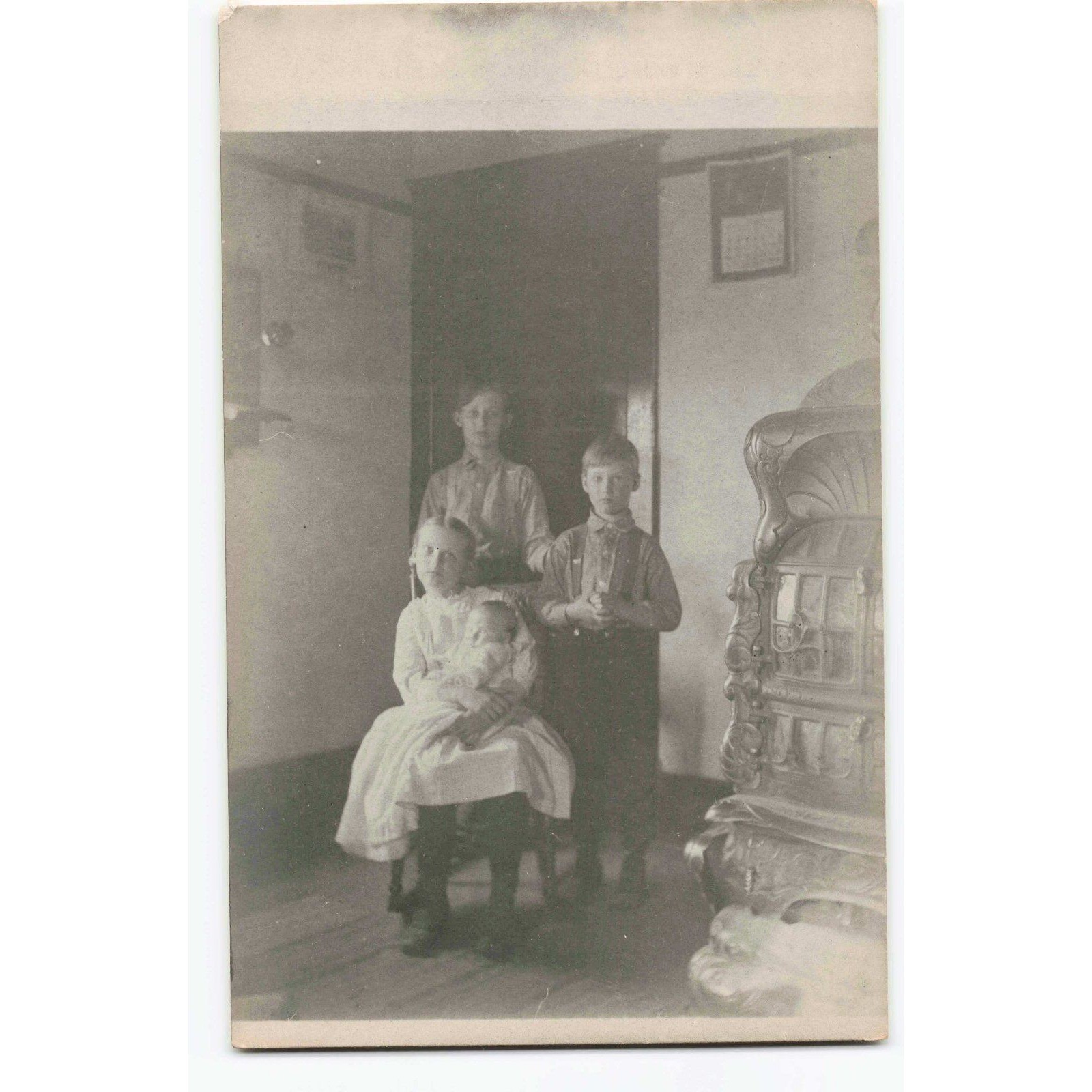 RPPC 1920 Bullock Family Four Children Ornate Parlor Stove Real Photo Postcard