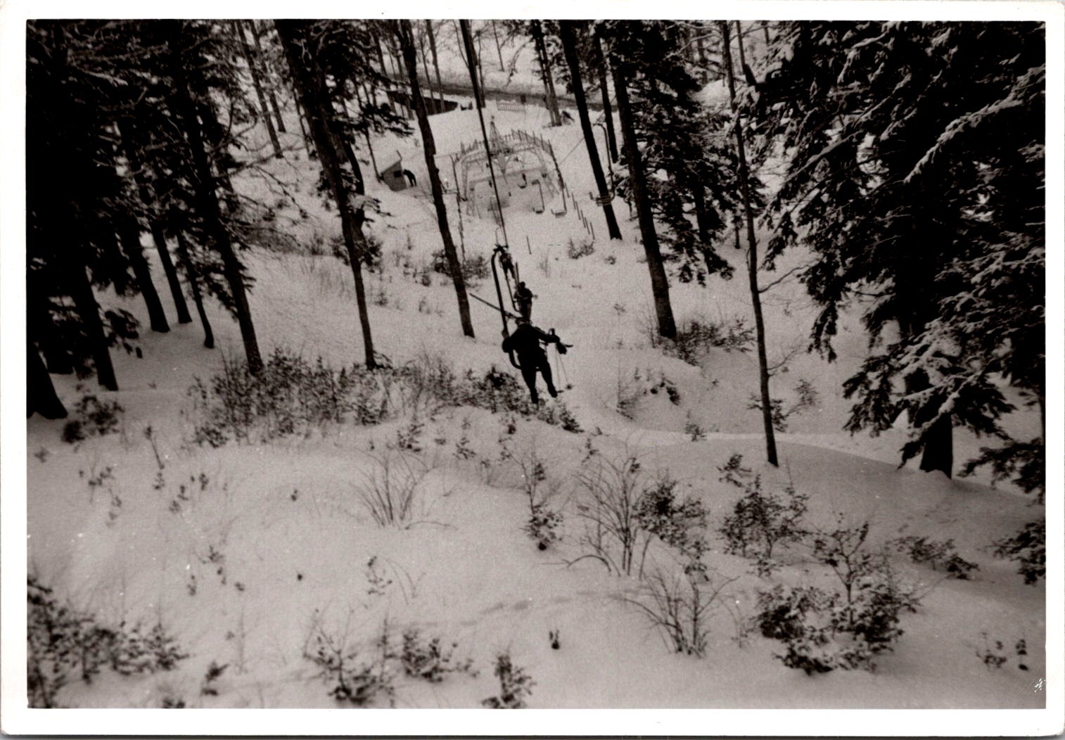 Skier on Vintage Chairlift over Snowy Woods, 1950s B&W Snapshot Photo