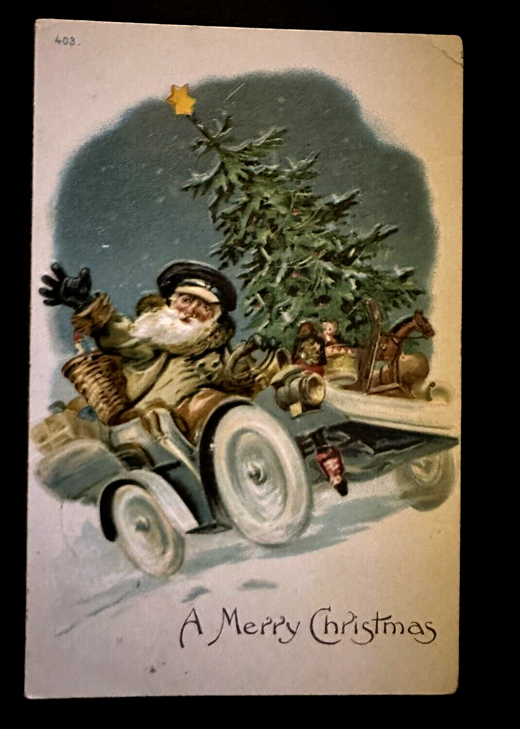 Unusual~Brown Robe Santa Claus in Car with Tree~Toys~Antique~Xmas~Postcard~k454