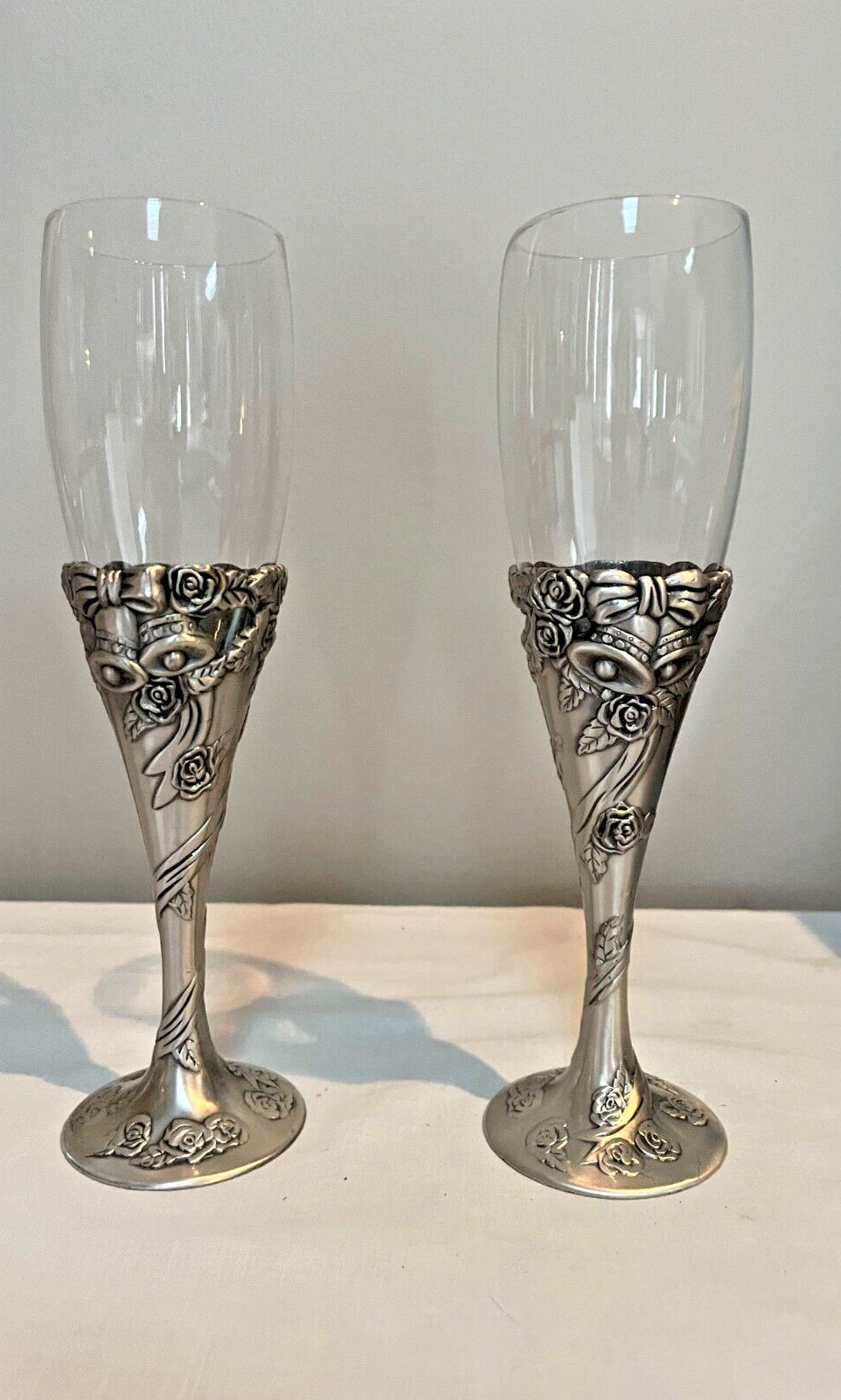 Elegant Glass w/Metal Base silver flute glasses w/metal bells & roses - set of 2