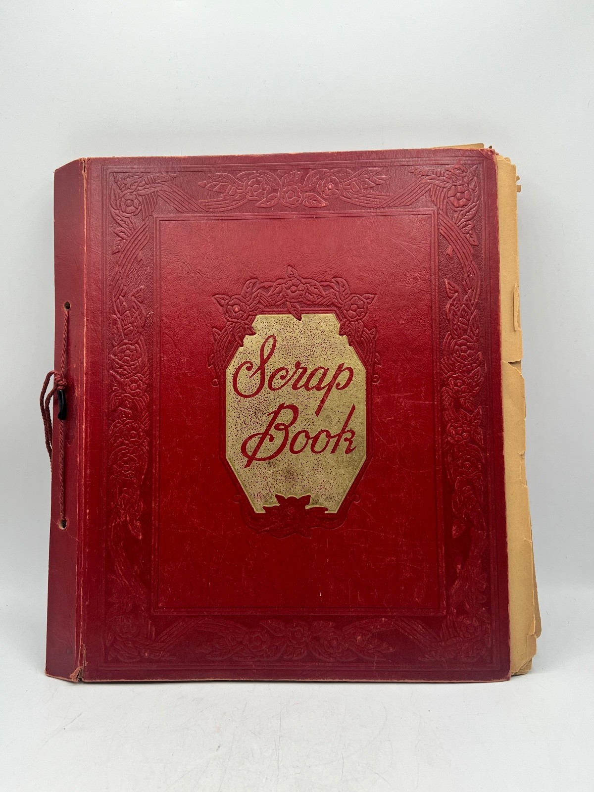 Vintage red scrap book filled with cut out clippings from 50's 60's
