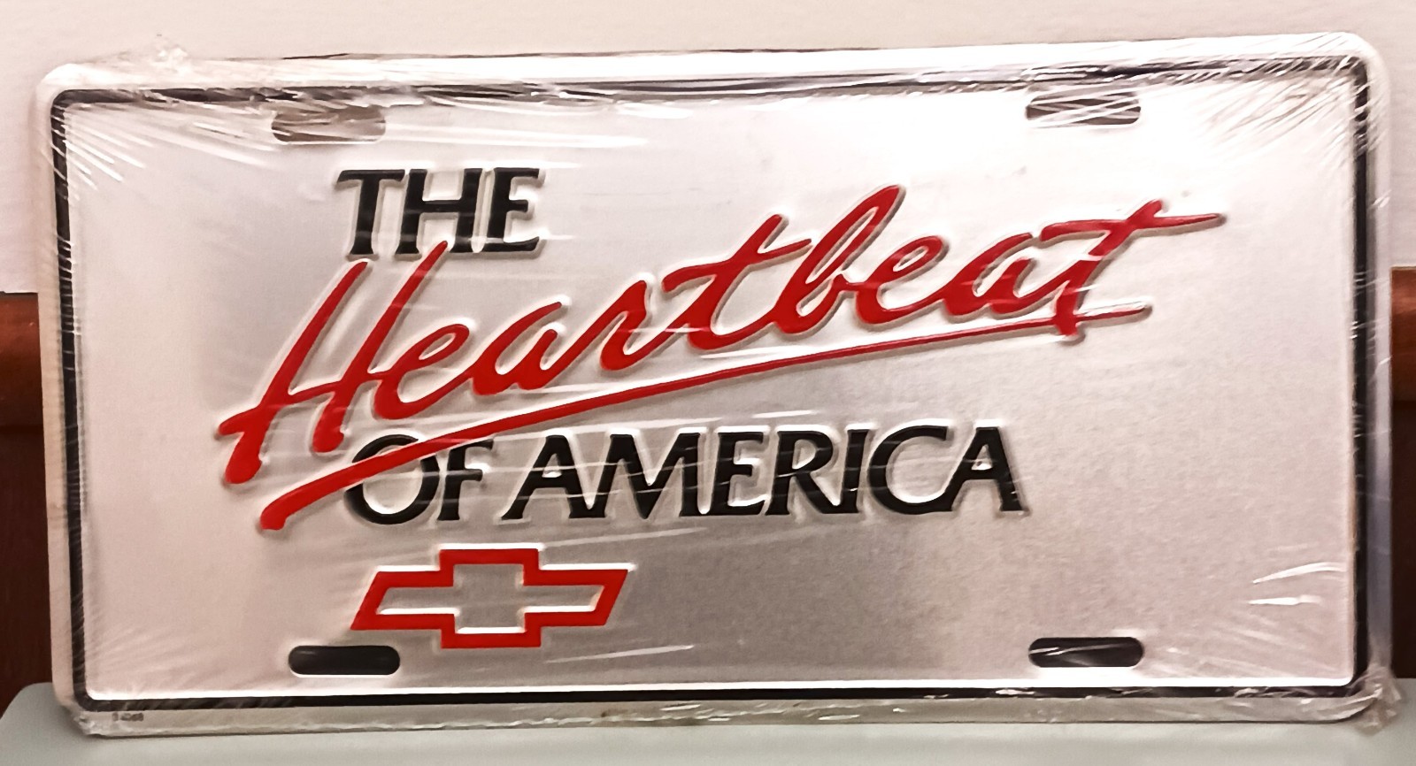Vintage NOS The Heartbeat of America Chevrolet Booster License Plate Silver Red