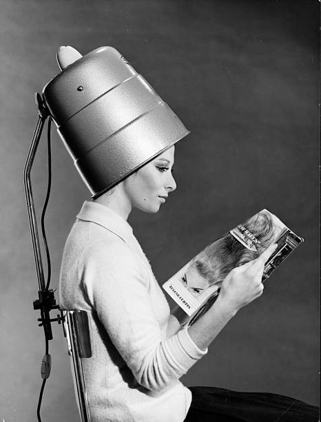 Young woman reading a magazine sitting a chair a back To this a su- Old Photo