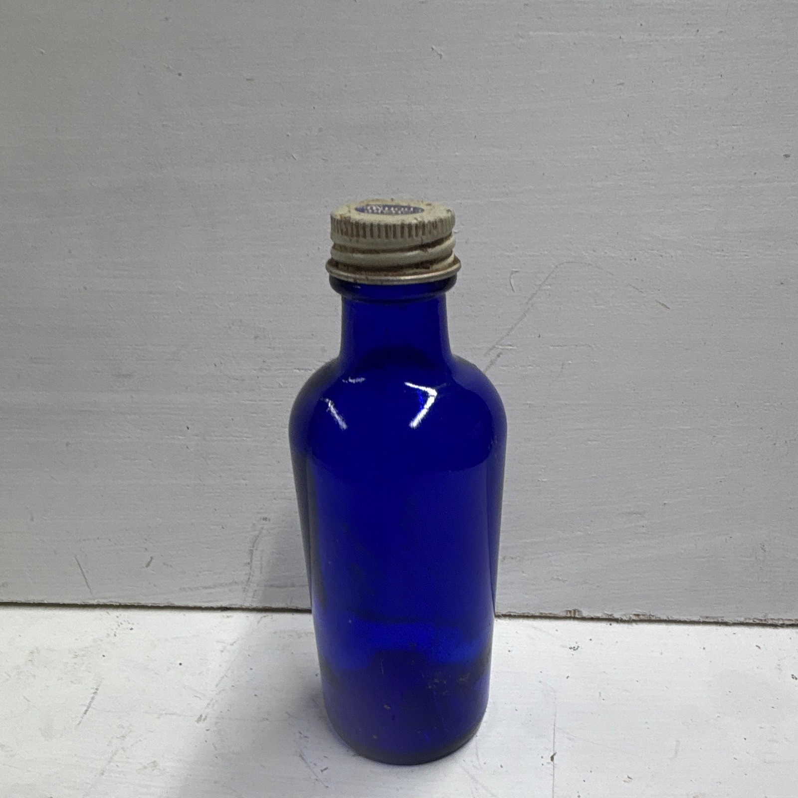 vintage cobalt blue glass medicine bottle made by Sharp & Dohme