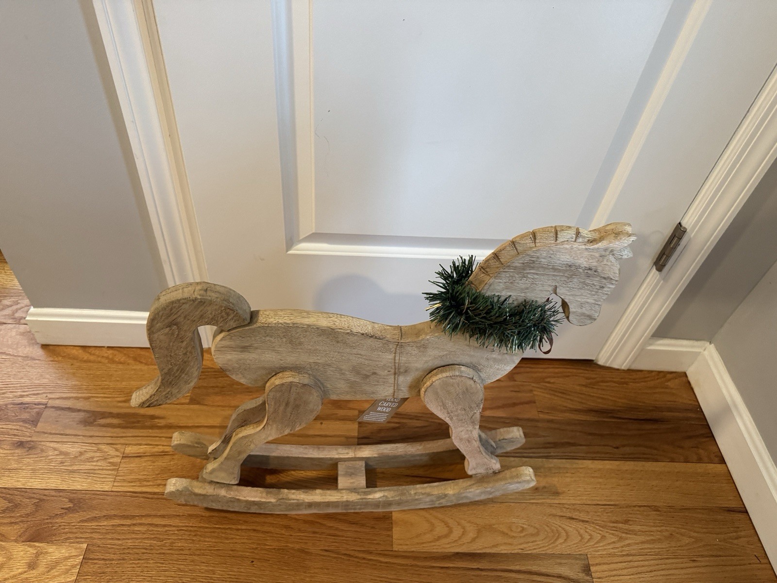 Wooden rocking horse Christmas decor with greenery