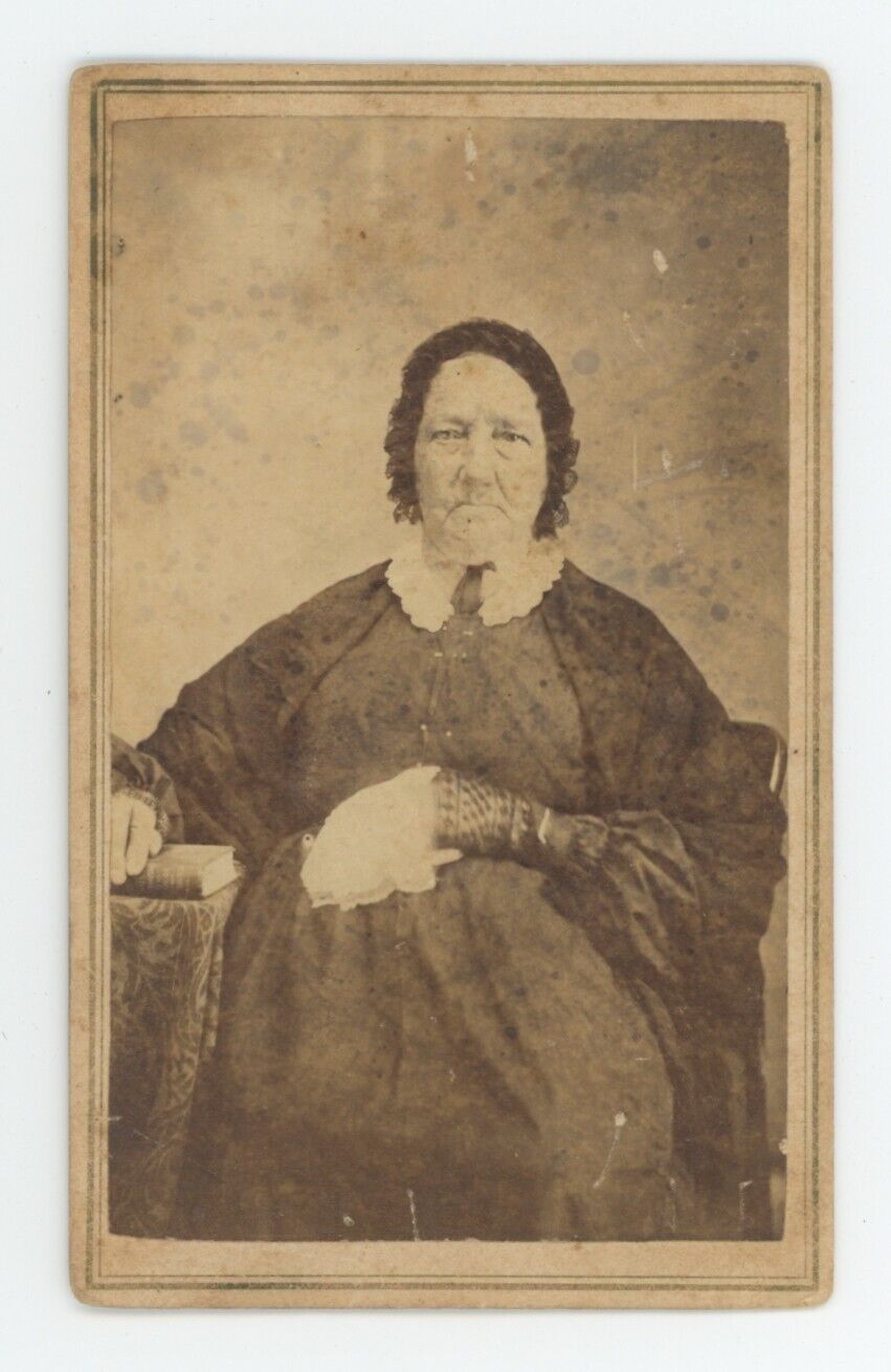 Antique CDV Circa 1860s Stern Looking Older Woman Sitting With Hand On Bible