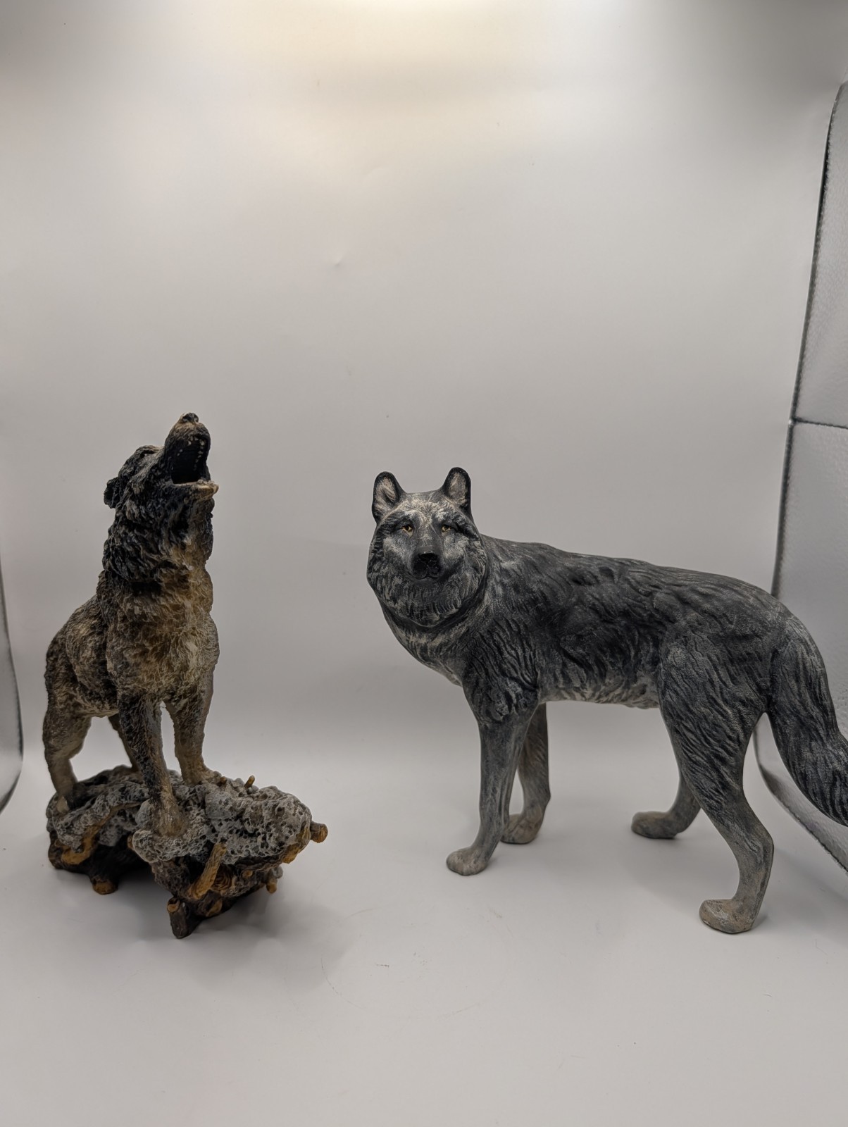 Set Of 2 Wolf Figurines 7.5 And 8 Inches Tall. 1 Ceramic And One Epoxy.