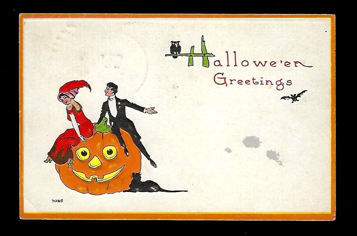 c1915 S. Bergman Halloween Postcard Couple Sitting on Pumpkin Cat Embossed