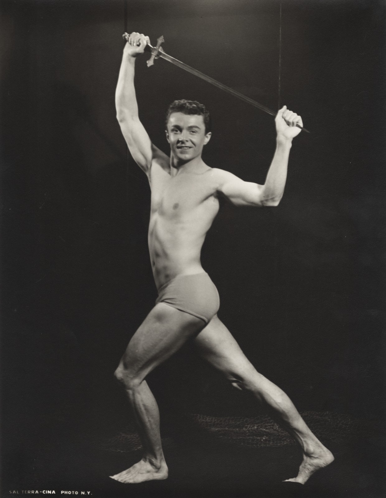 c. 1950's Bodybuilder Holding Sword Overhead Large Photograph by SAL TERRACINA