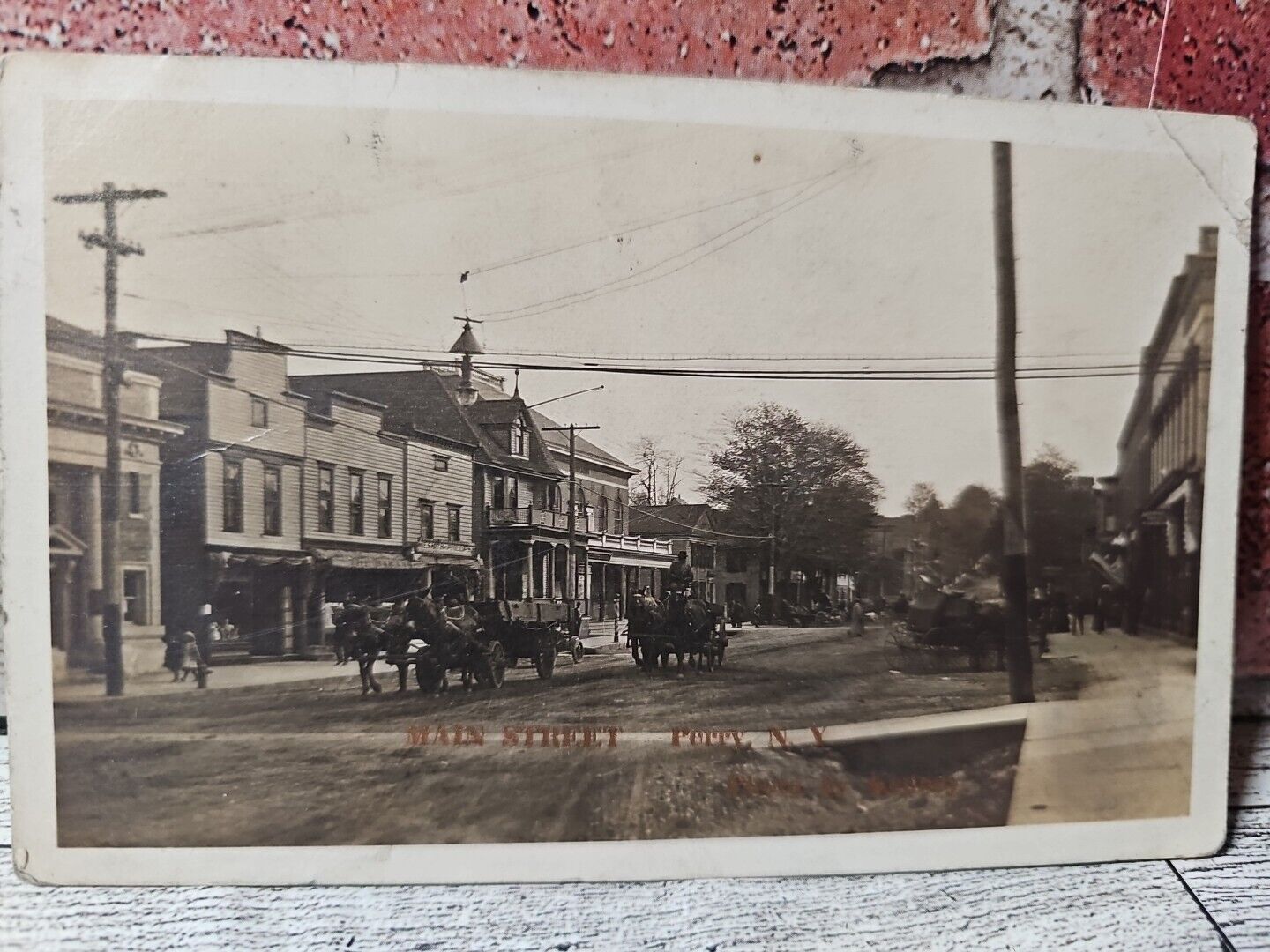 1913 Perry, New York REAL PHOTO Main Street Horses Buildings Postcard