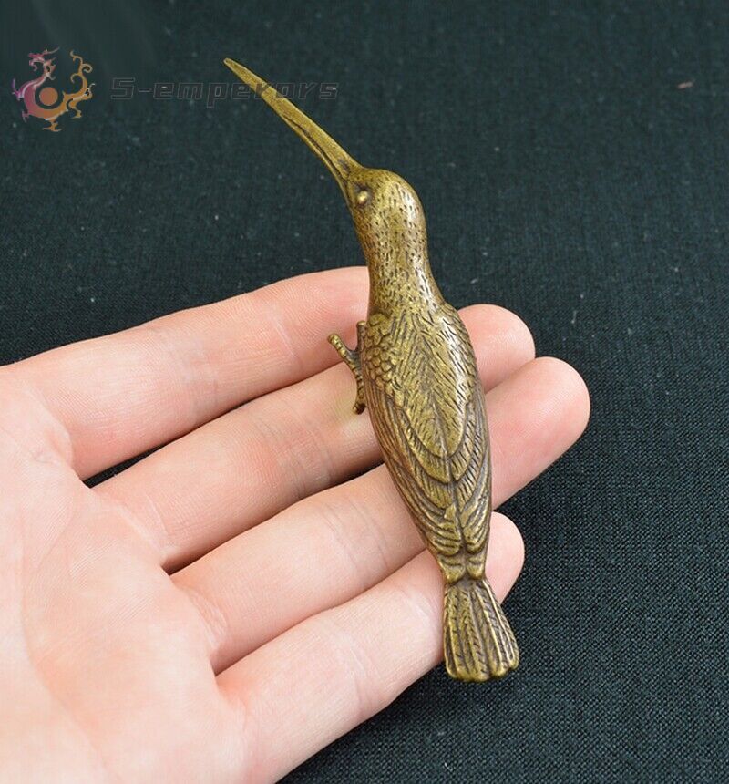 Antique bronze ware with brass and a solid long billed hummingbird