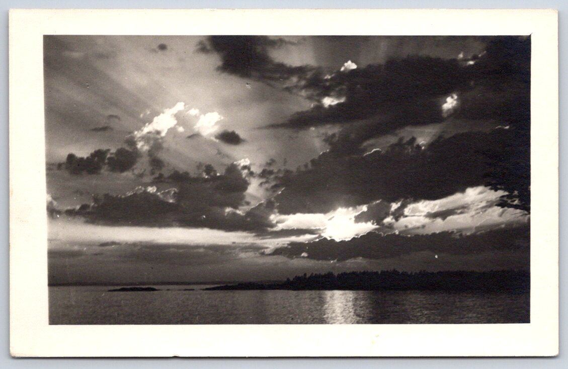 Vintage USA Postcard Dramatic Sunset Over Lake Clouds 1940s RPPC