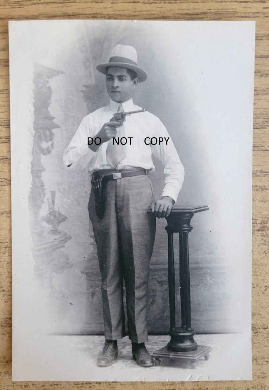 1900S REAL PHOTO POSTCARD LATINO MAN HOLDING PISTOL WEARING FEDORA HAT OUTLAW ?