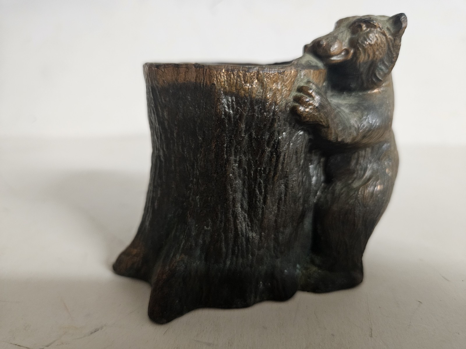 Bronze Grizzly Bear Getting In A Tree Stump