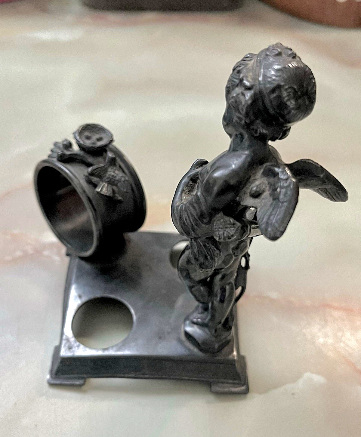 Victorian figural silver-plated napkin ring holder made by the Wilcox Silver Co. Victorian figural silver-plated napkin ring holder made by the Wilcox Silver Co.