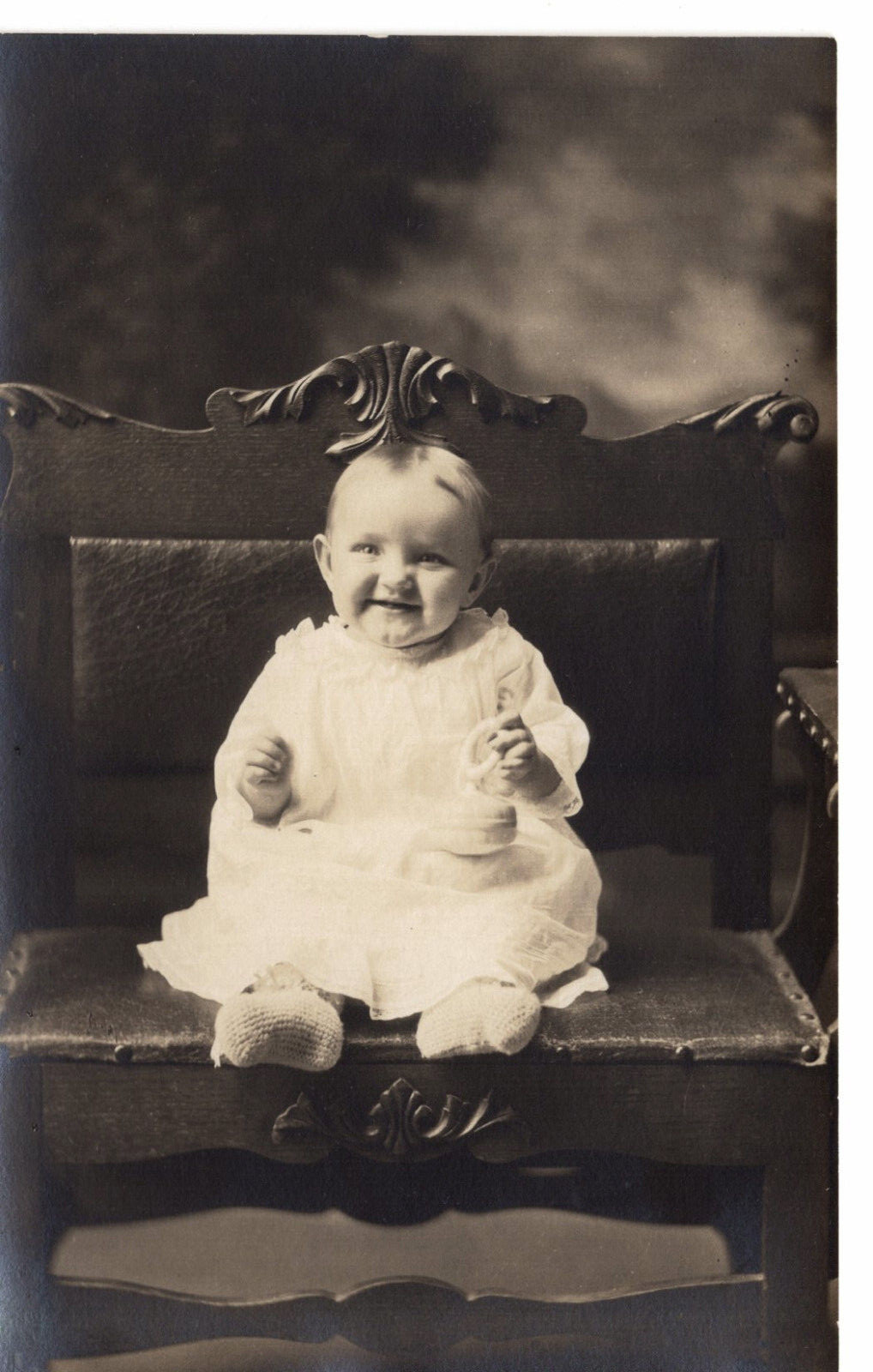 Postcard RPPC Studio Photo Grinning Little Baby Cute Girl Fancy Bench -9499