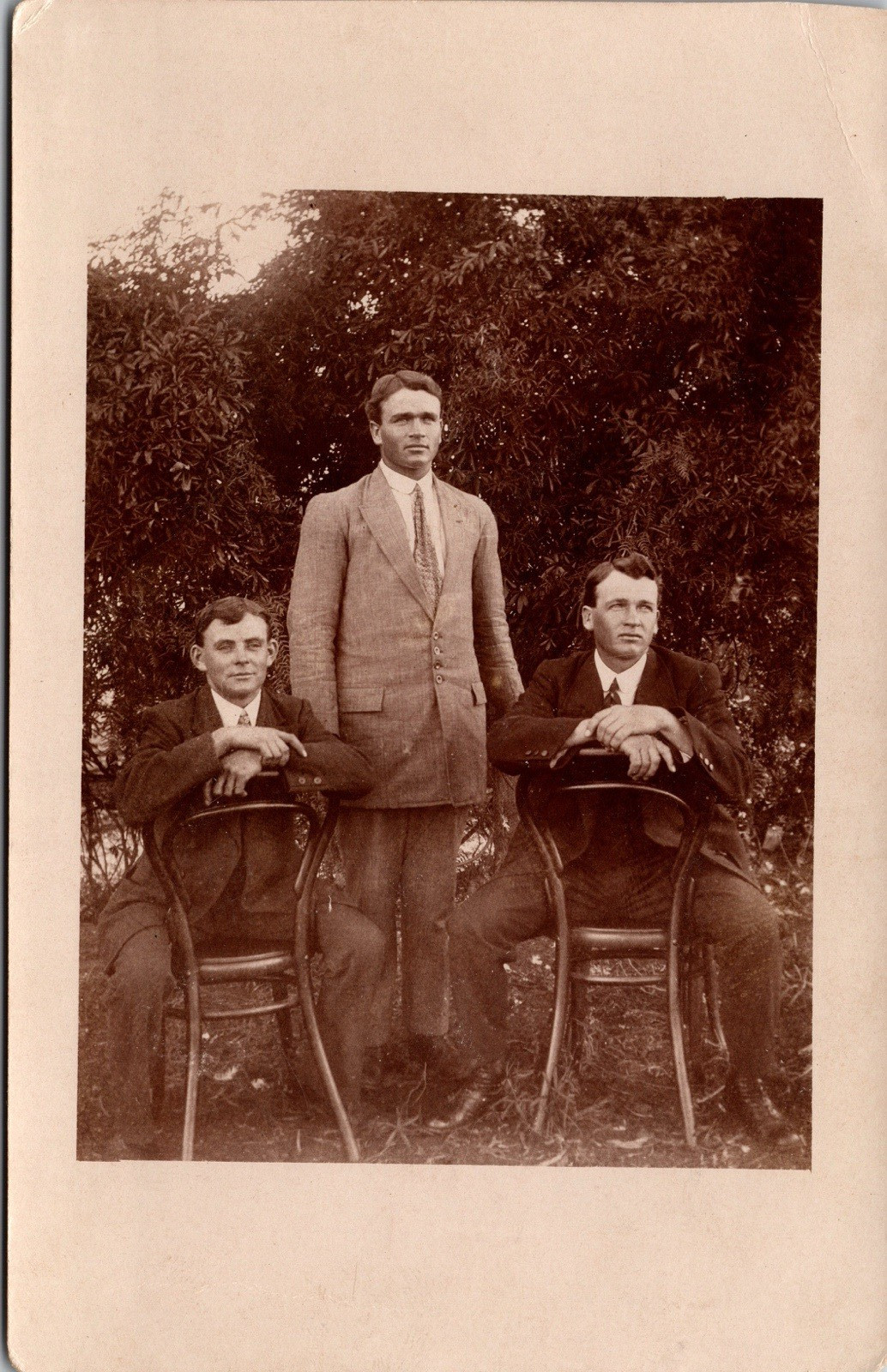 Postcard Men Sitting Reverse on Chairs outside Brothers? Real Photo RPPC 1914