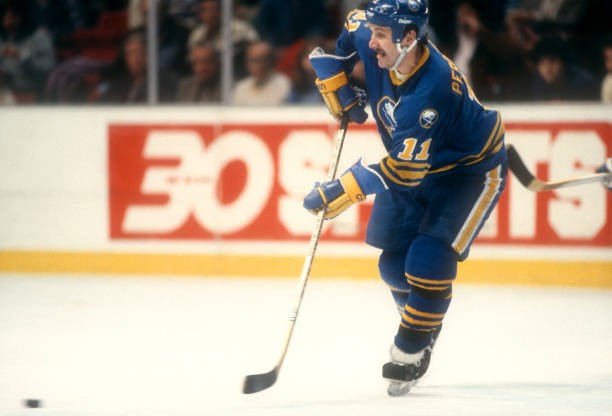 Gilbert Perreault Buffalo Sabres passes the puck at an NHL game v - Old Photo