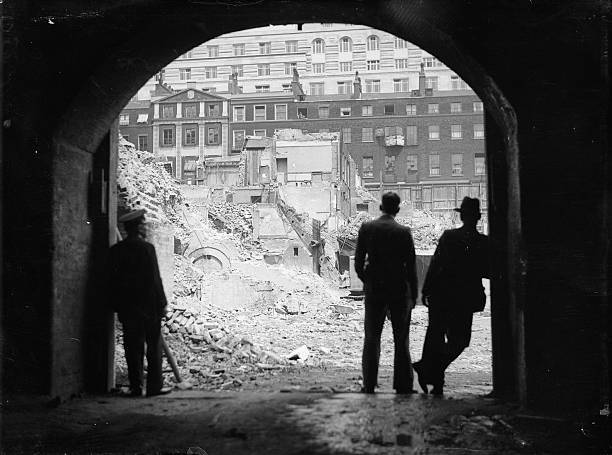 Construction workers continue their task of demolishing the - 1936 Old Photo 1