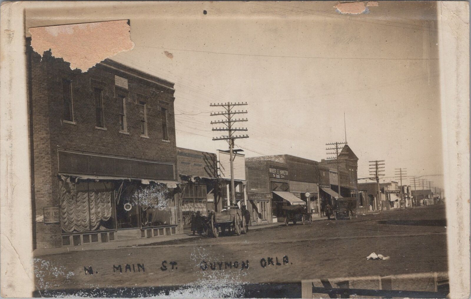 Main Street, Stores, Cars, Dirt Road Guymon Oklahoma 1915 RPPC Photo Postcard