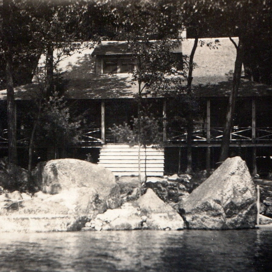 c1910s Lakeside Cabin Lodge Porch US Flag Boulders Lake RPPC Cyko Postcard Photo