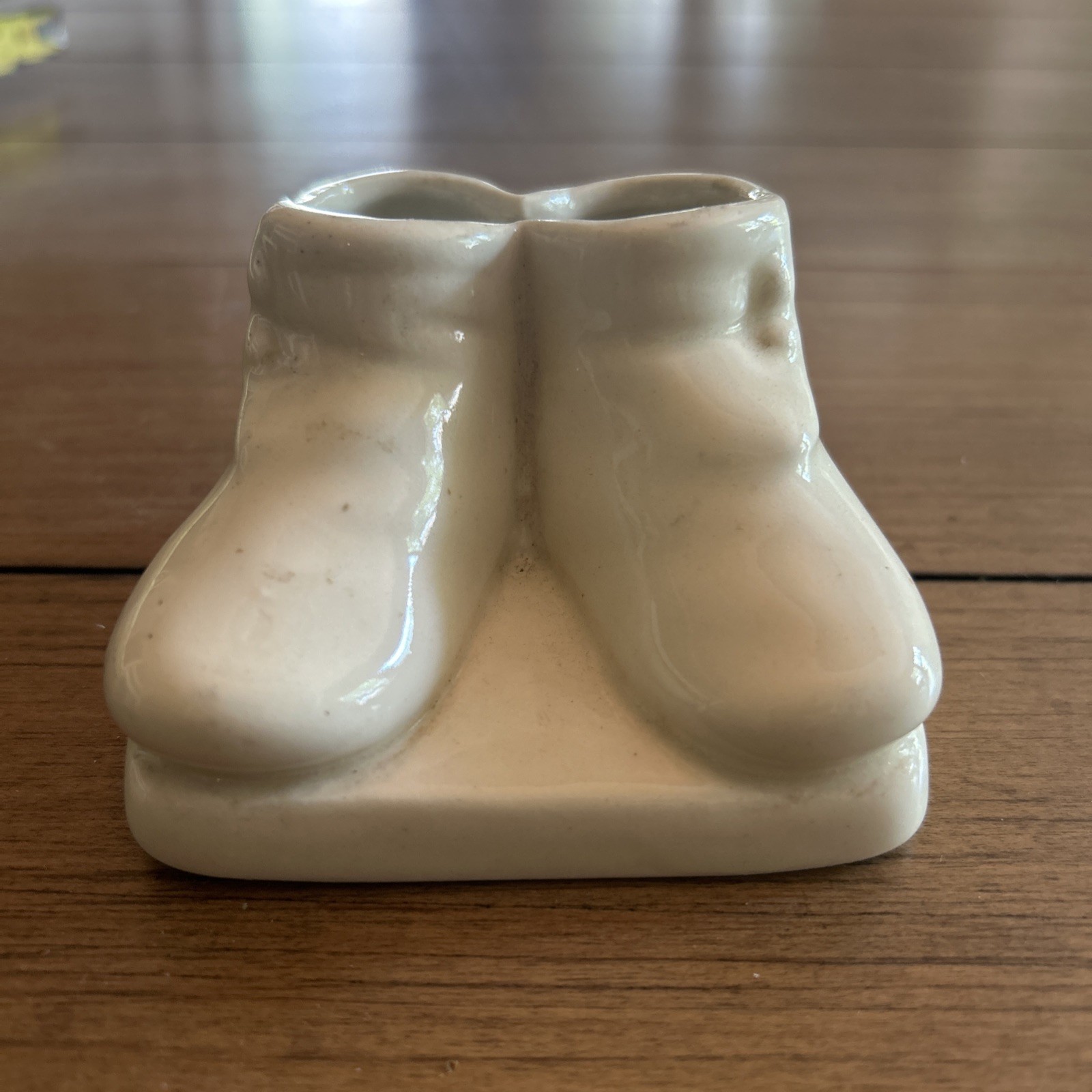 Vintage ceramic double baby shoe planter, likely produced in the 1950s
