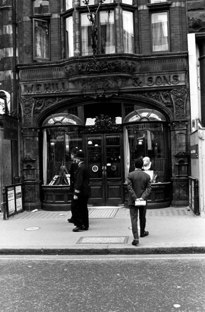 Two British policemen passing by WE Hill Sons violin shop New Bond- Old Photo