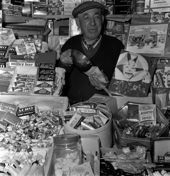 shopkeeper is pictured in a sweet shop 1950s Old Photo shopkeeper is pictured in a sweet shop 1950s Old Photo