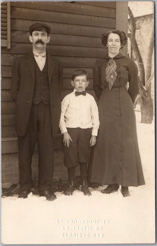 Vintage 1910s Real Photo RPPC Postcard Family Posing Next To House in the Snow
