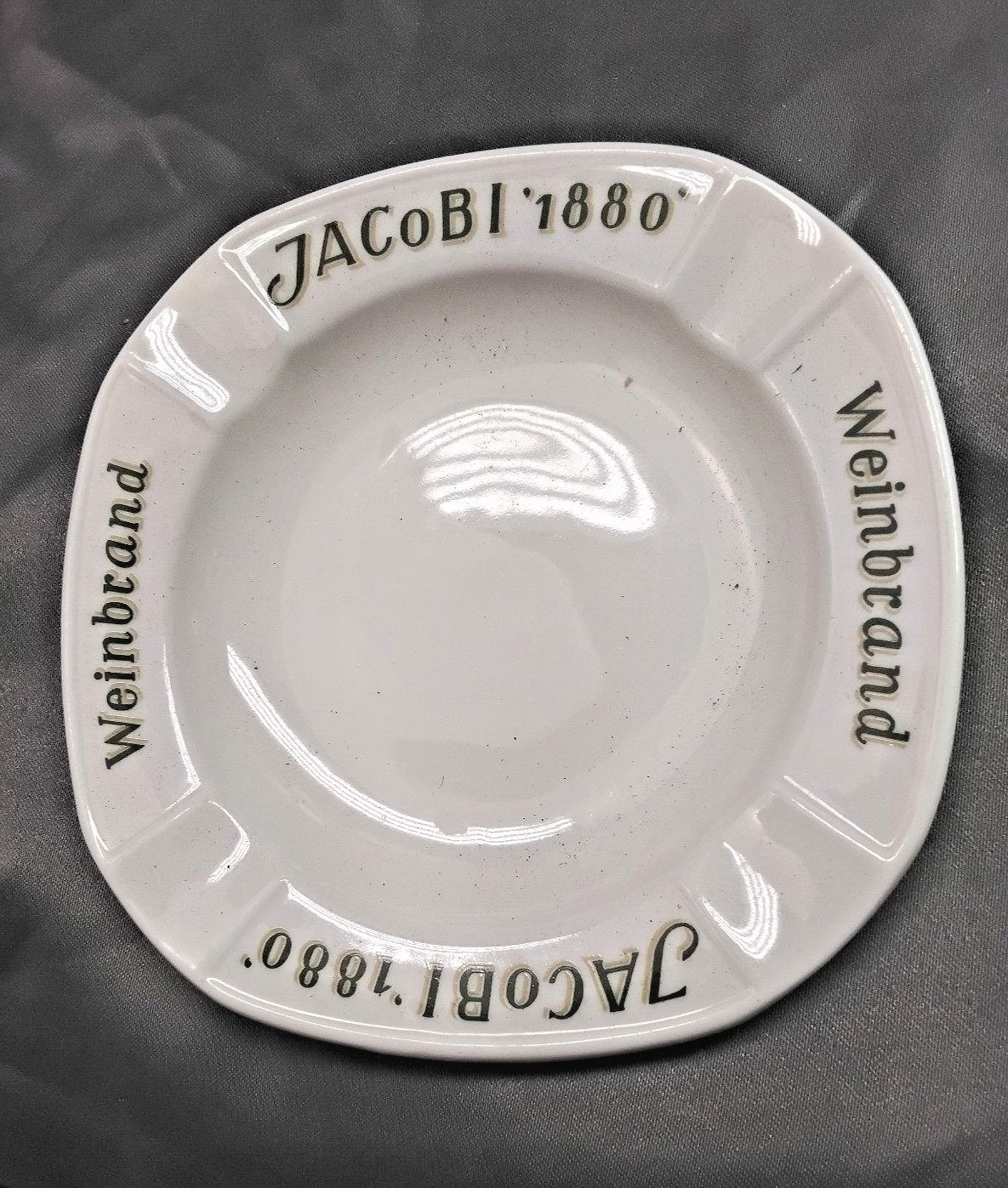 Jacobi 1880 weinbrand ceramic large ashtray  four slot  mfg, by Fischer co.