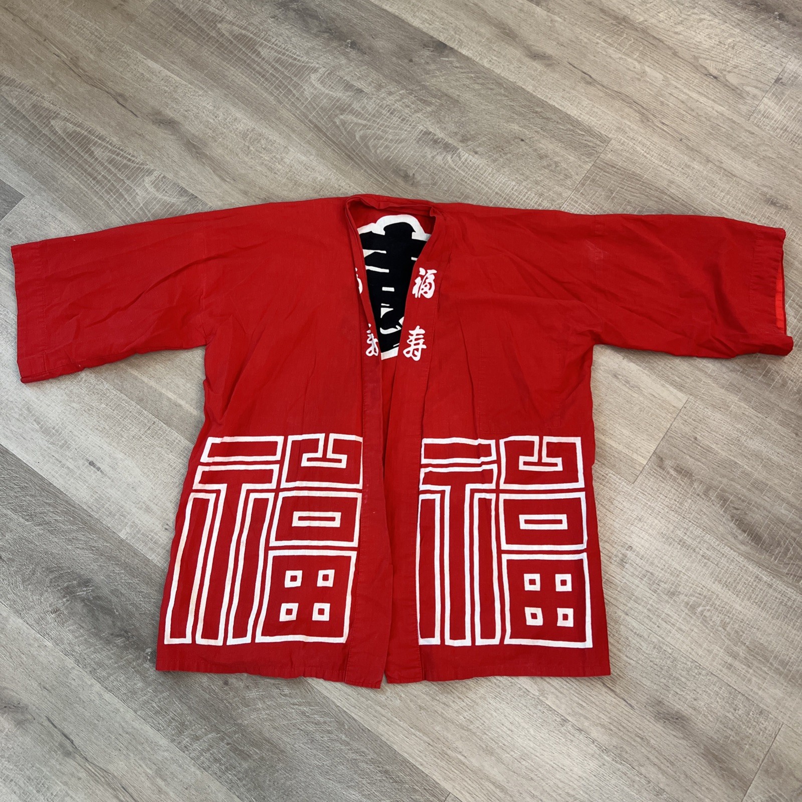 Vintage red Japanese happi coat featuring bold white kanji characters