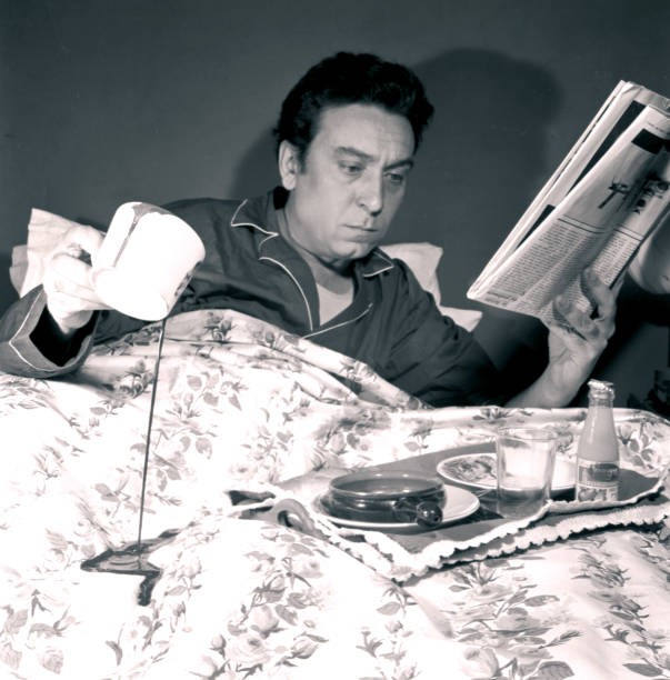 Italian writer Luciano Bianciardi reading a newspaper lying bed Bi- Old Photo