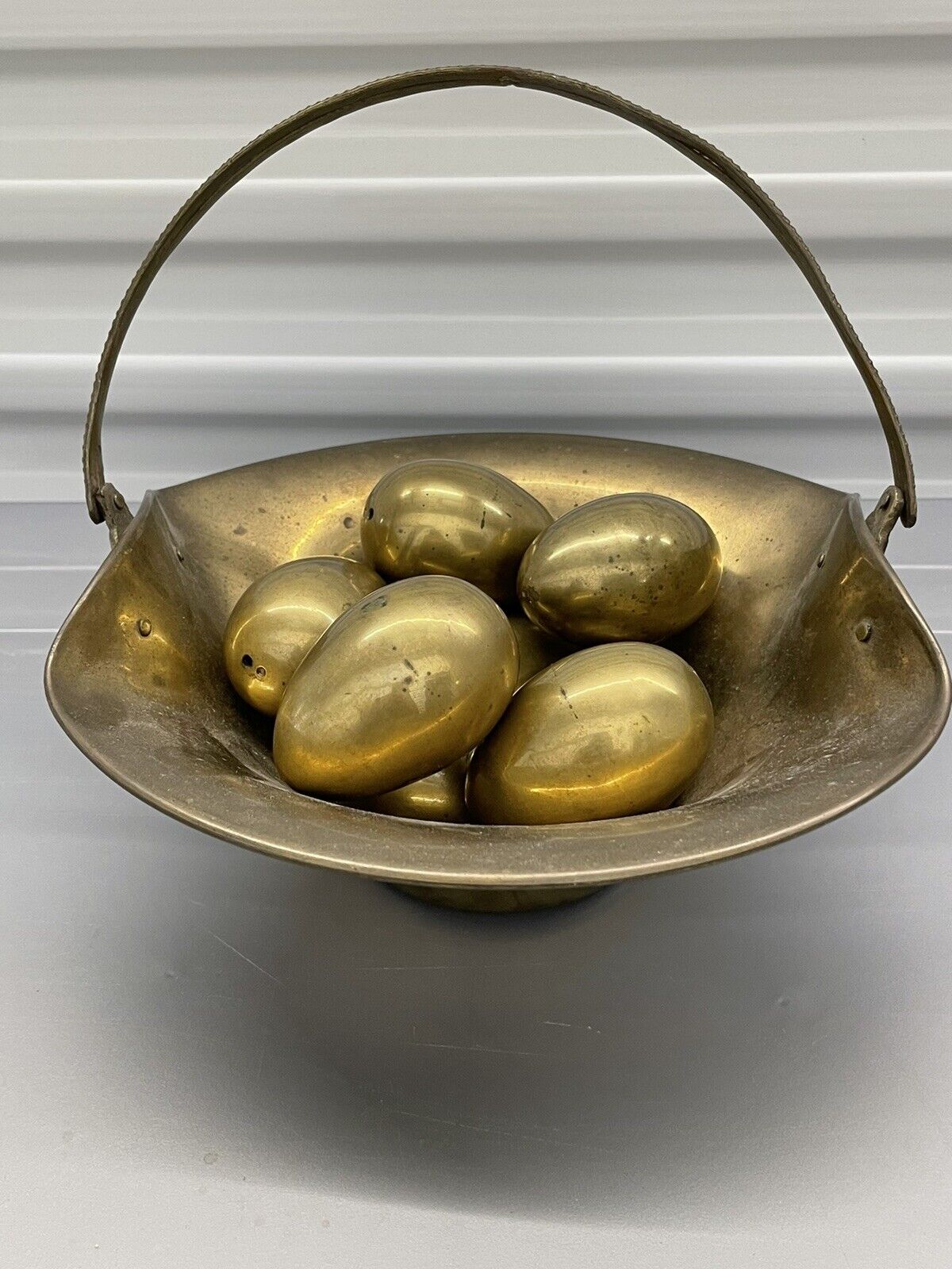 Vintage Fluted Brass Handled Basket filled with 8 Elegant Brass Eggs