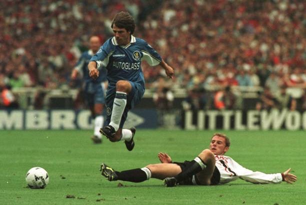 Chelsea\'s Gianfranco Zola leaps over an outstretched Nicky Butt du- Old Photo