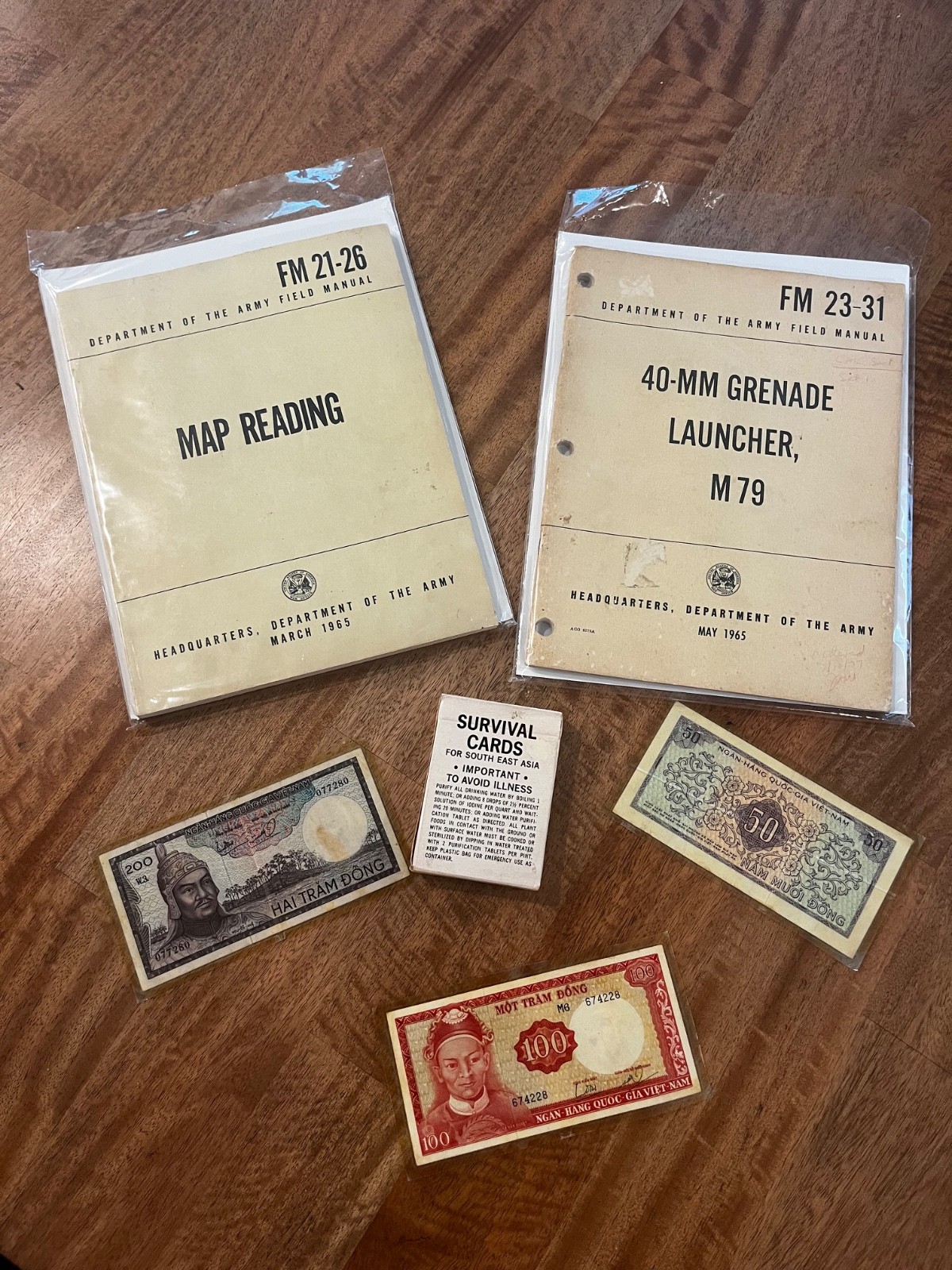 Vietnam War Manuals, Card, and Dong Vet Grouping Original Display for reen