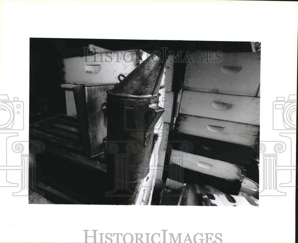 1995 Press Photo Smoker sitting on top a stack of empty bee hives. - noa74018