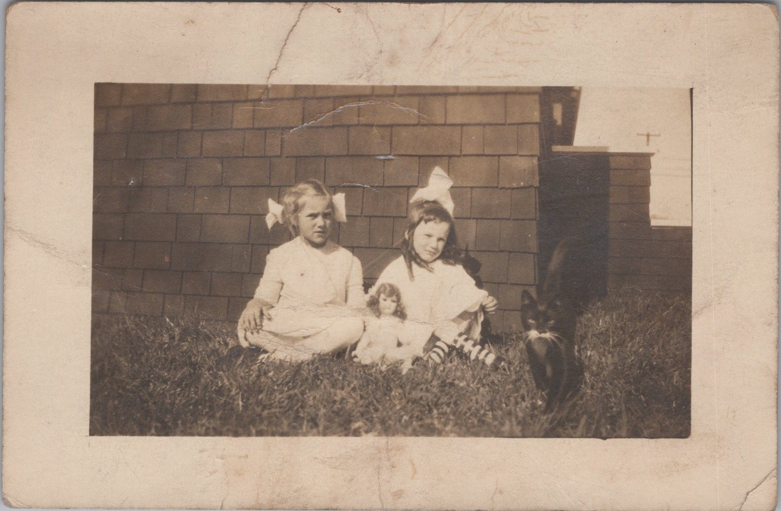 Two girls posed outdoors RPPC Doll and Cat Antique Postcard
