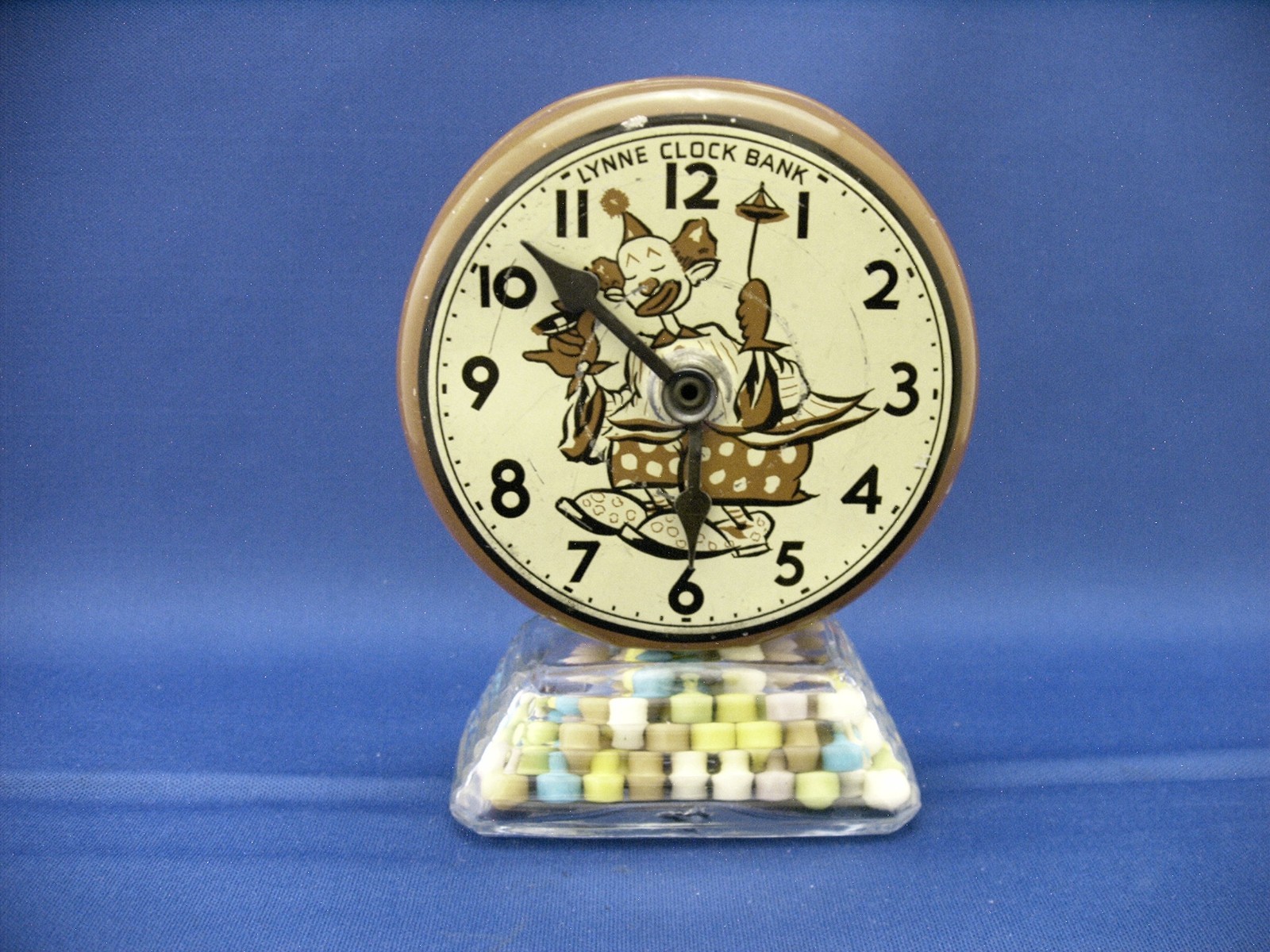 VINTAGE GLASS & TIN LYNNE CLOWN CLOCK BANK TOY CANDY CONTAINER CIRCA 1950