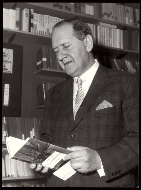 The Italian writer psychiatrist Mario Tobino browsing through a co- Old Photo