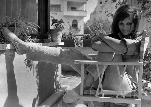 The Italian actress Claudia Cardinale sitting a chair relaxing a r- Old Photo