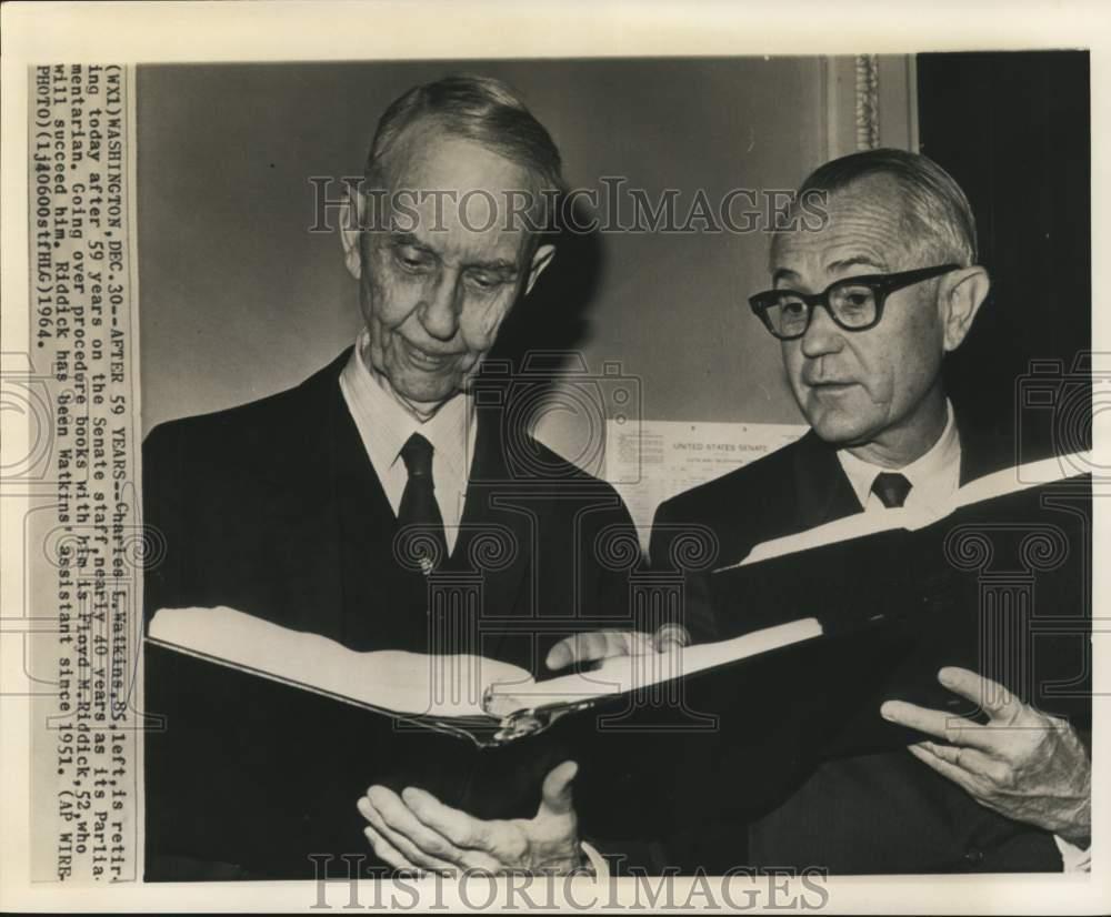 1964 Press Photo Retiring Charles Watkins gives procedure books to Floyd Riddick