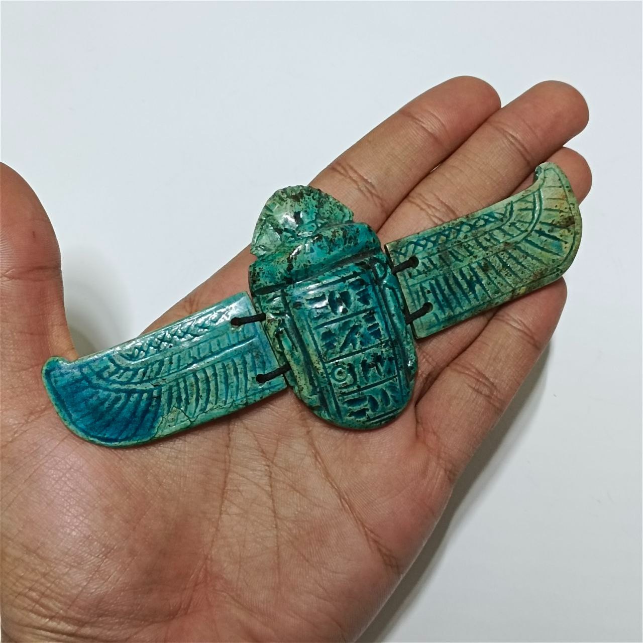 Handmade Egyptian winged scarab in an antique style, a collectible artifact Handmade Egyptian winged scarab in an antique style, a collectible artifact