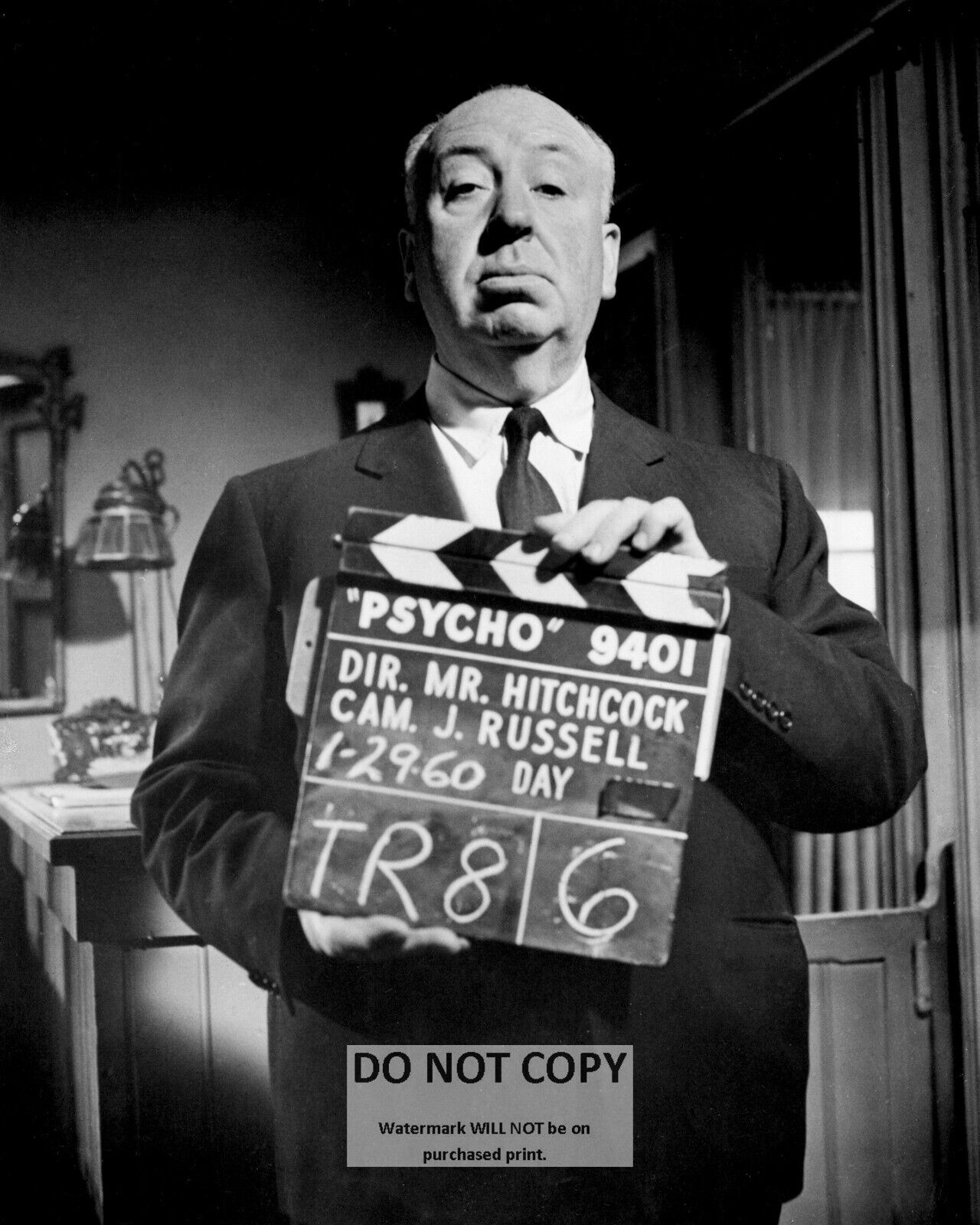 ALFRED HITCHCOCK HOLDING CLAPPERBOARD ON THE SET OF \