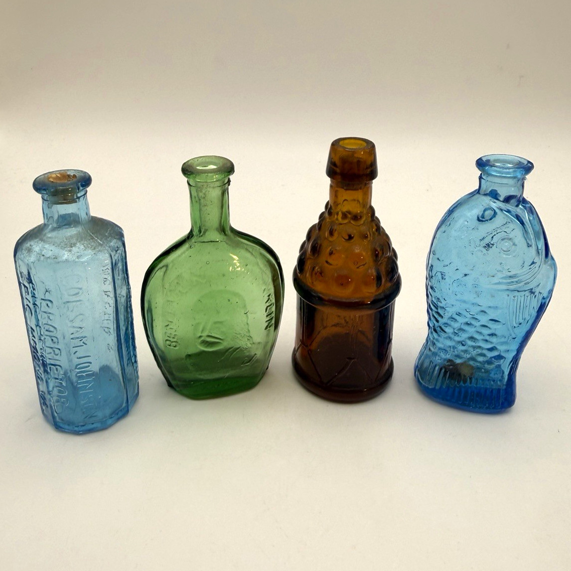 4 vintage mini glass bottles. Wheaton style 3” Taiwan Fish, drum, Ben Franklin