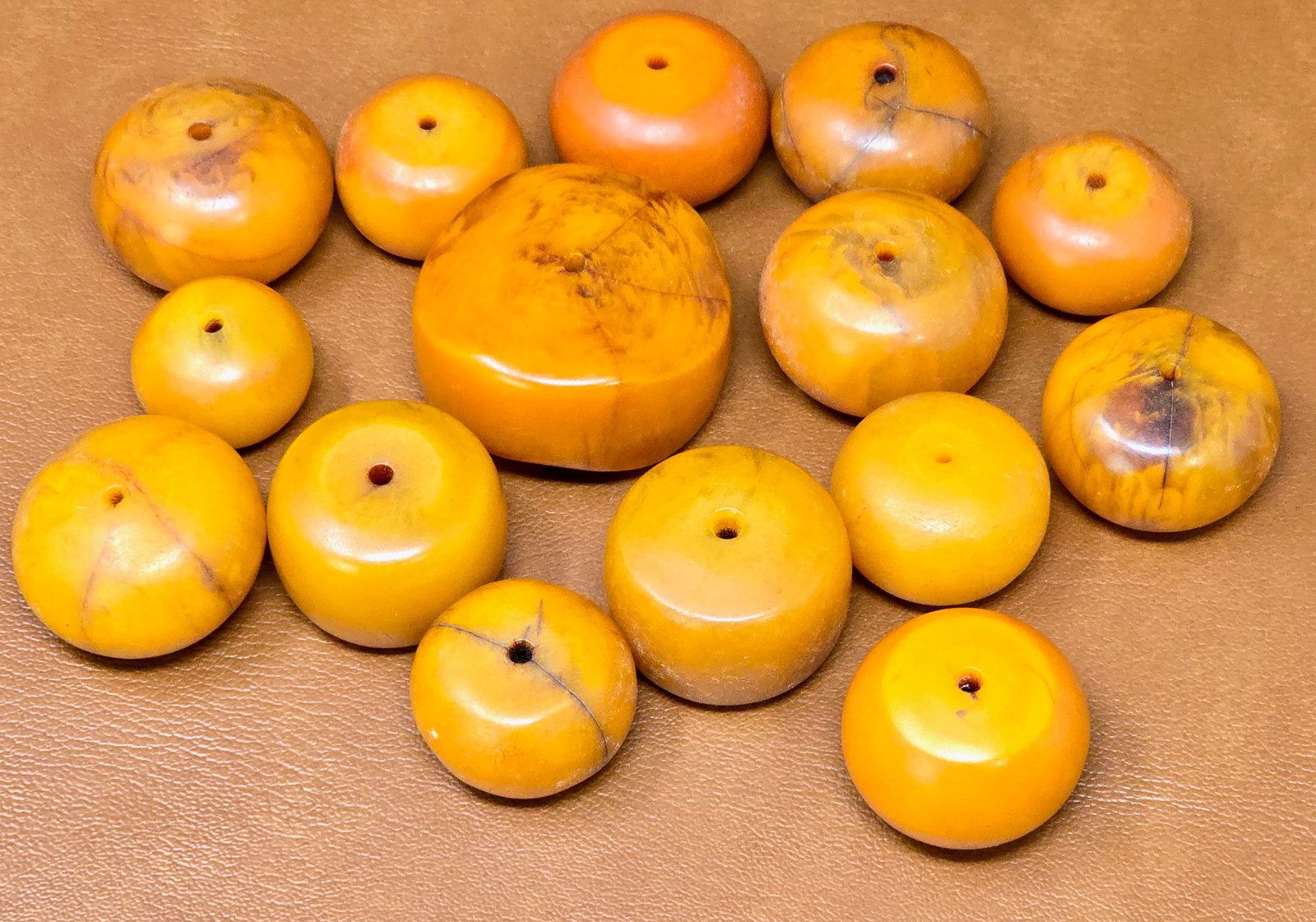 One Large  and 14 Small Butterscotch Amber Faturan Bakelite Round Bead