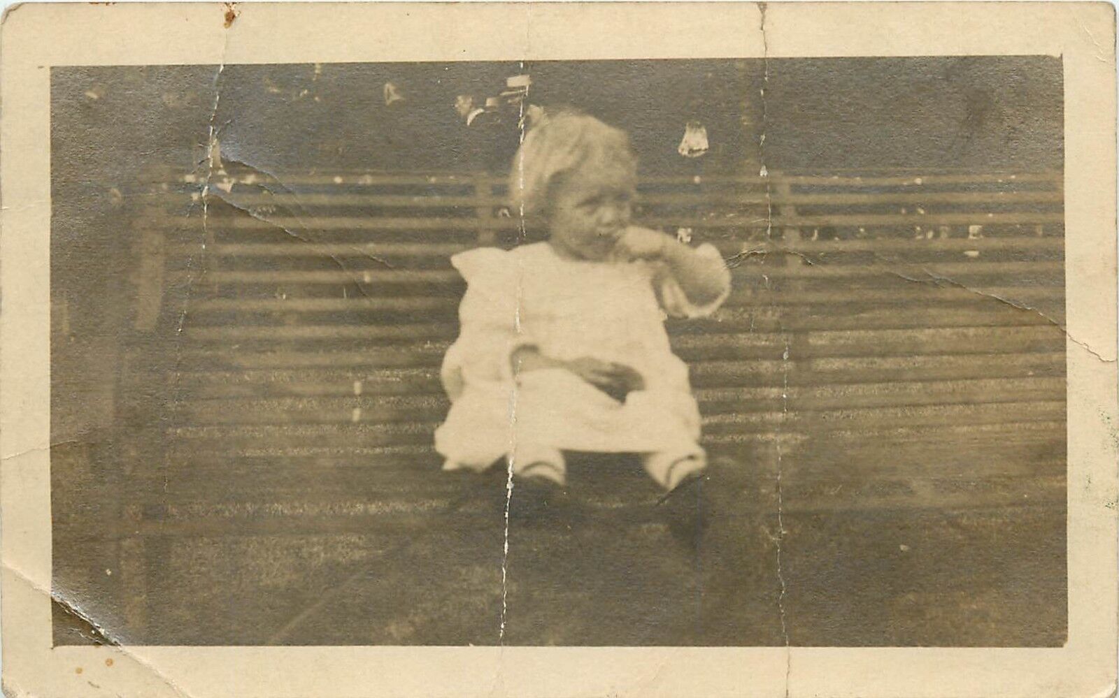 Young Girl in White Dress Sitting on a Park Bench RPPC Postcard