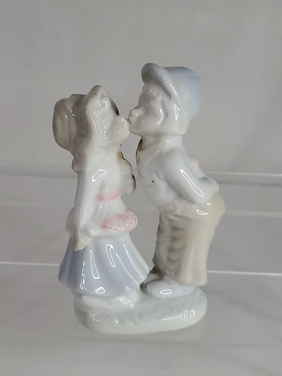 Vintage Porcelain Girl and Boy Kissing on the Cheek Holding Presents 