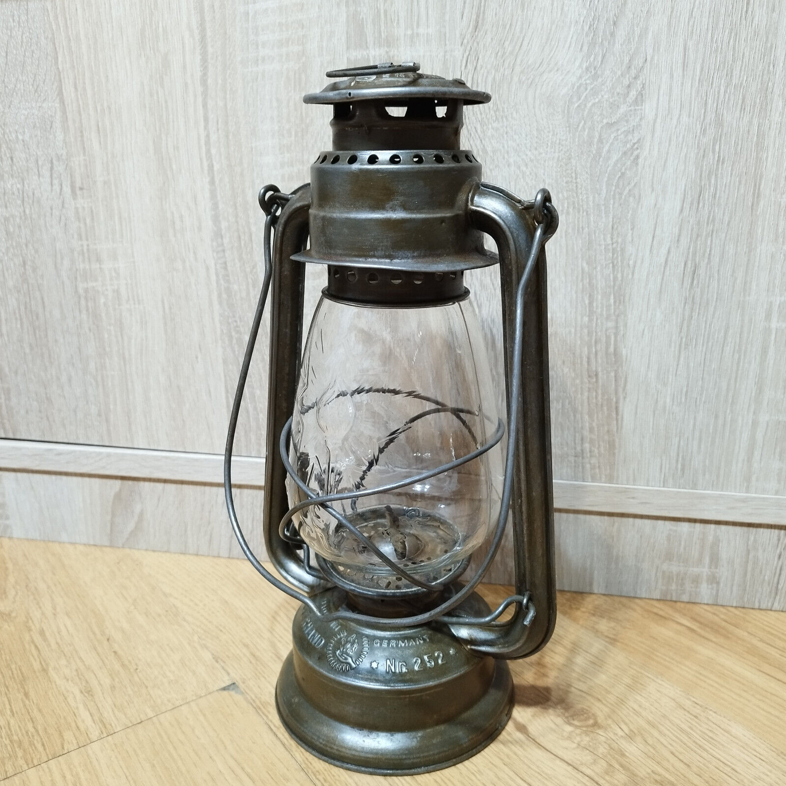 Old kerosene lantern FEUERHAND 252 Germany glass DITMAR hand holding a torch